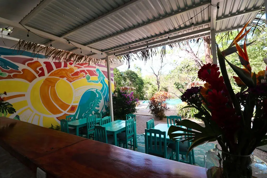 The shared dining area at Naya Nosara, with its painted mural wall