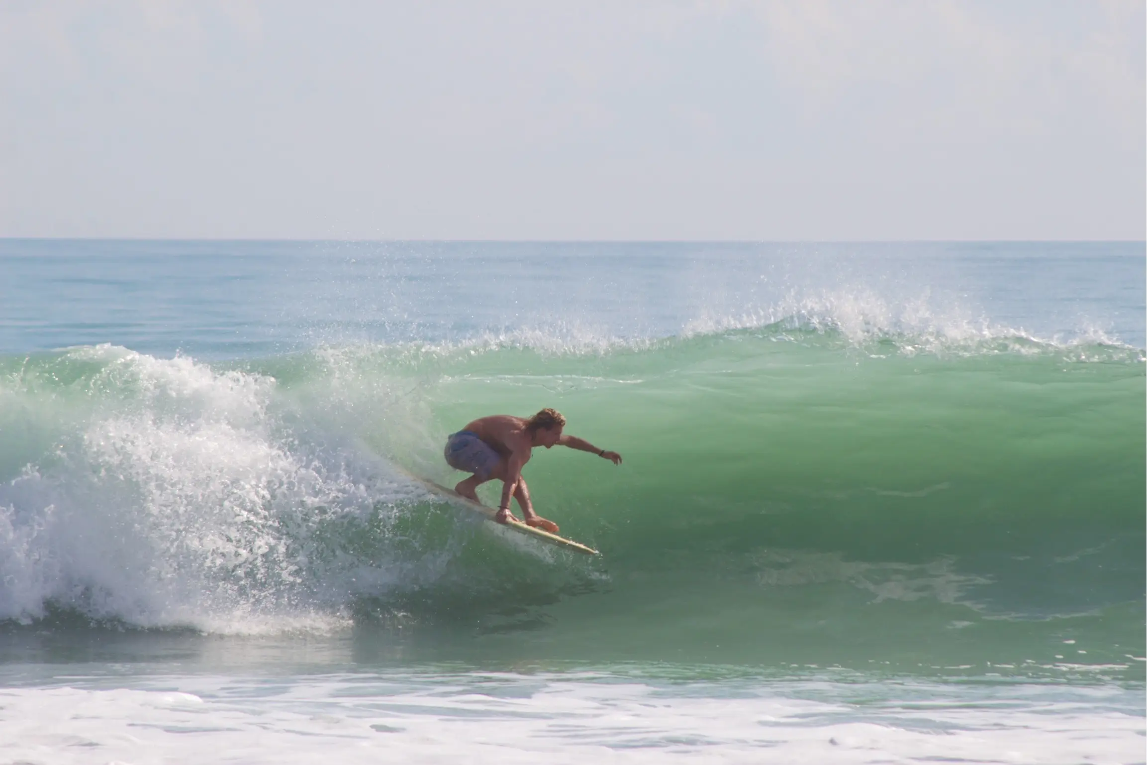 Bobby Conti surfing a green wave