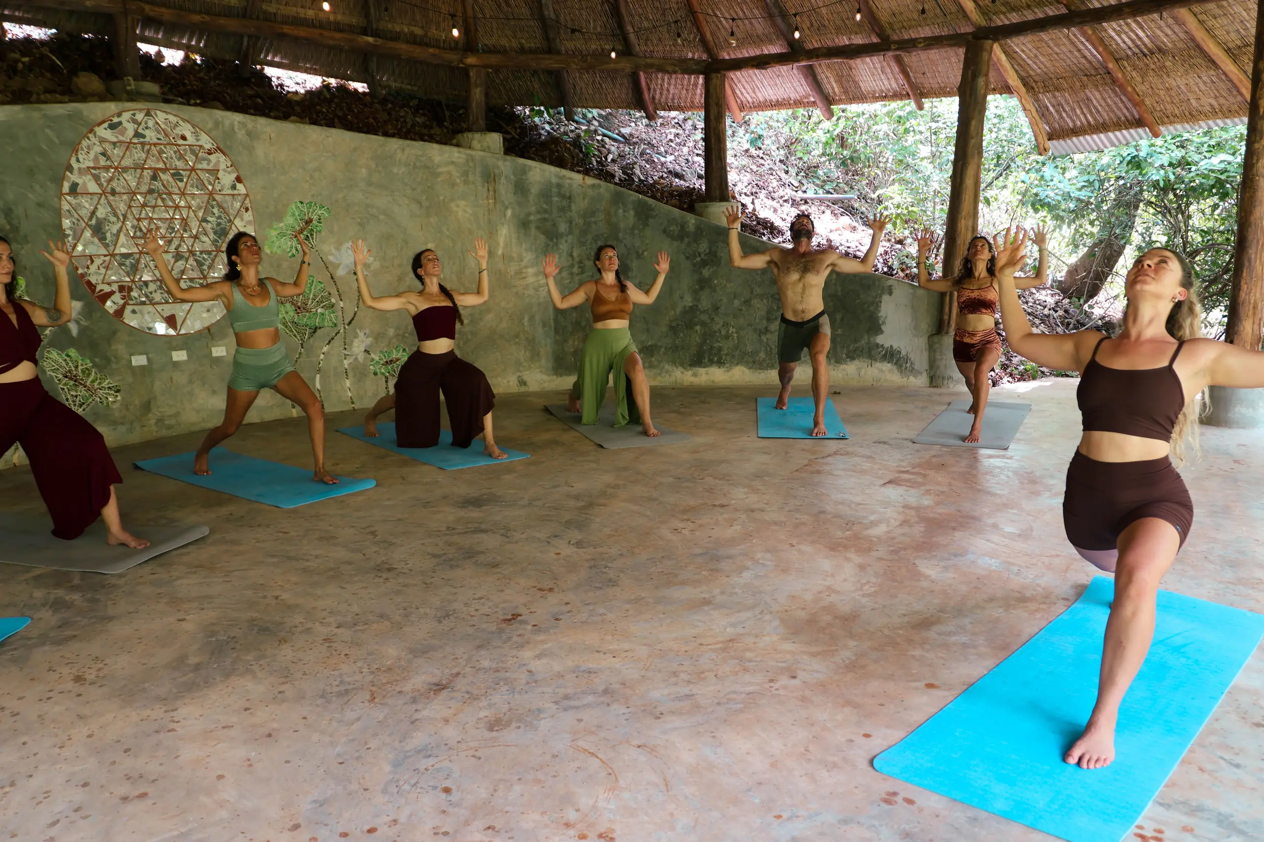 A group practicing yoga together in the shala at Naya Nosara